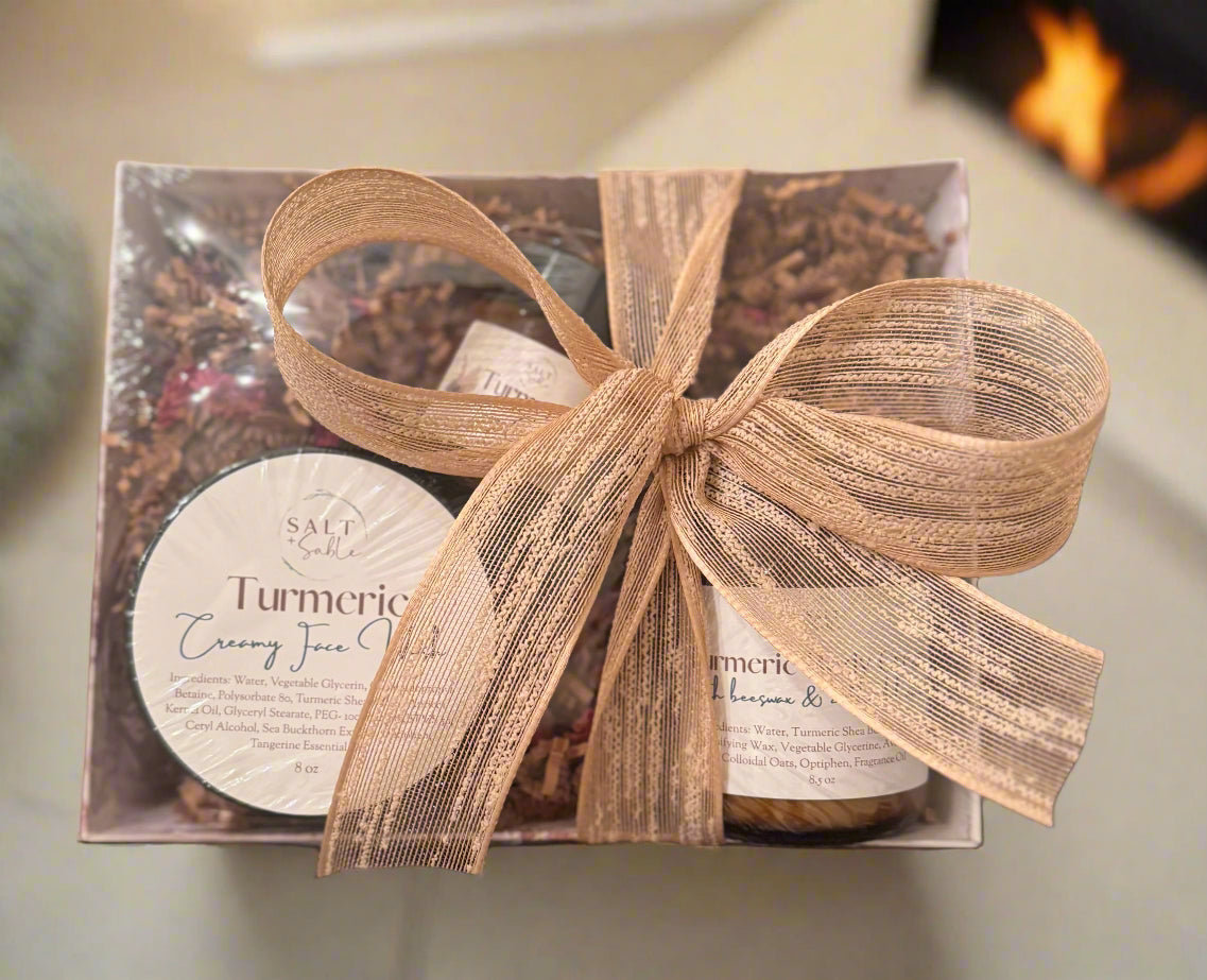 Gift set with turmeric cream and a decorative bow on a blurred background